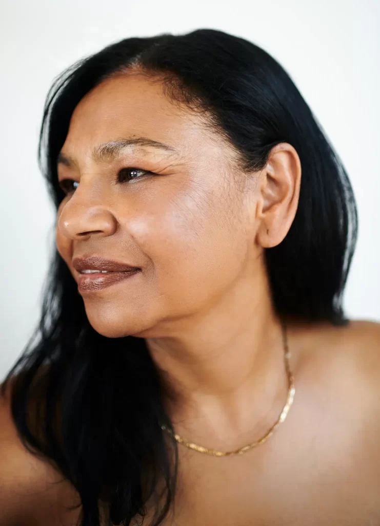 Woman with dark hair and gold necklace