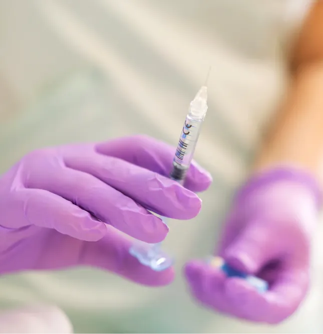 Healthcare professional holding syringe